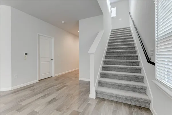 a view of an entryway with wooden floor