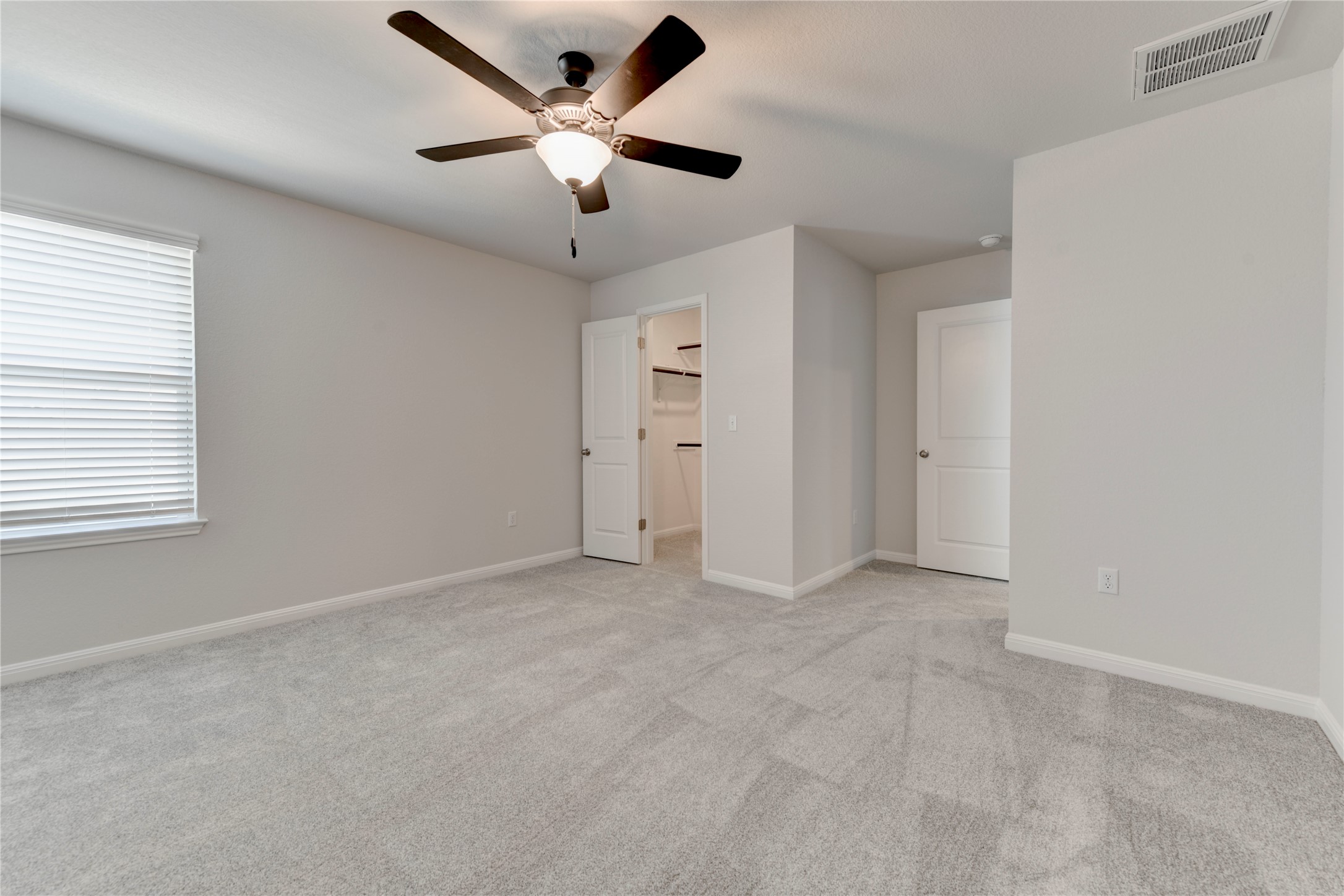 10716 Timber Brook Pass Austin, TX 78747 - Photo 25 of 33 an empty room with chandelier fan and windows