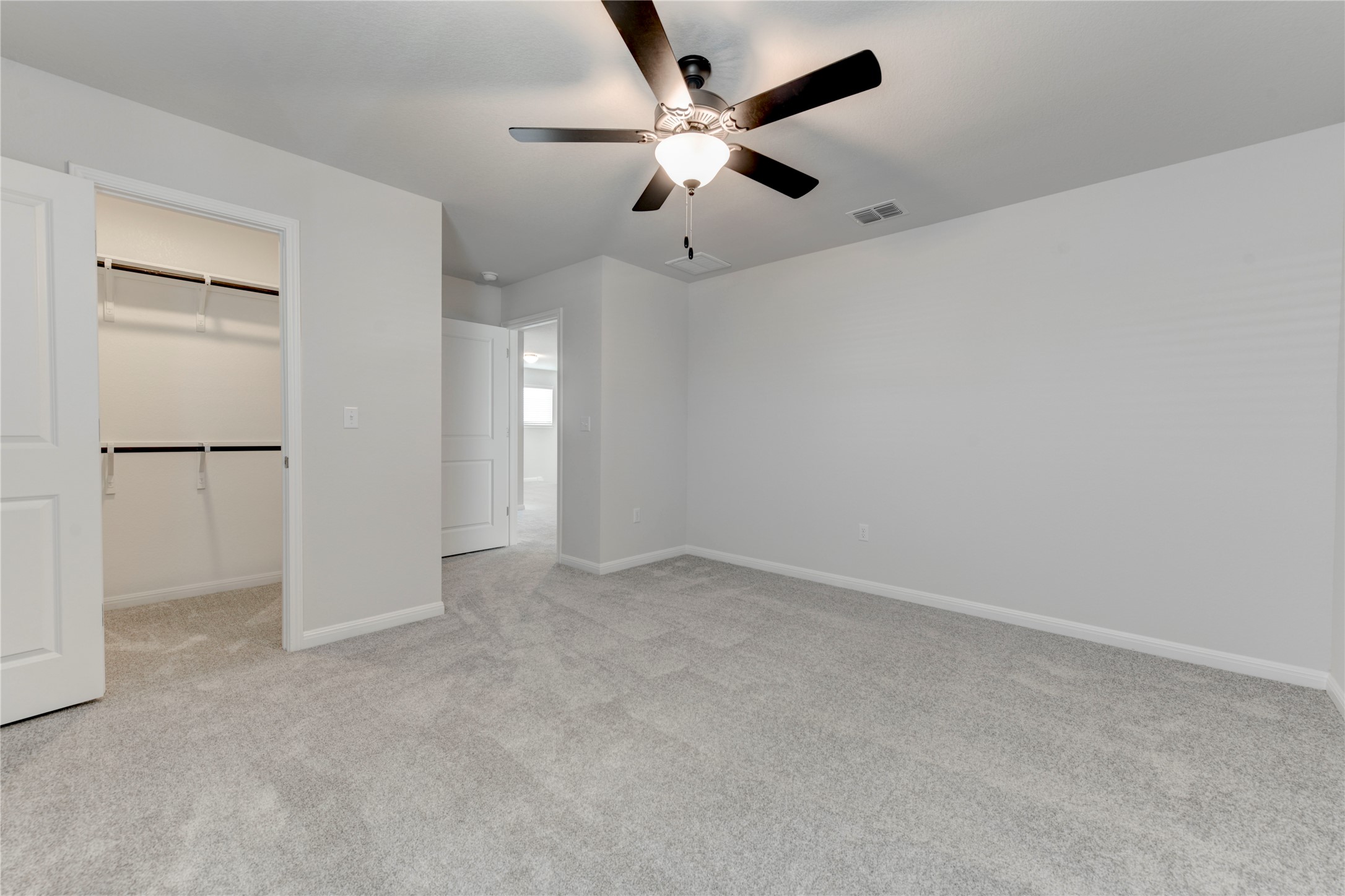 10716 Timber Brook Pass Austin, TX 78747 - Photo 26 of 33 an empty room with closet and ceiling fan