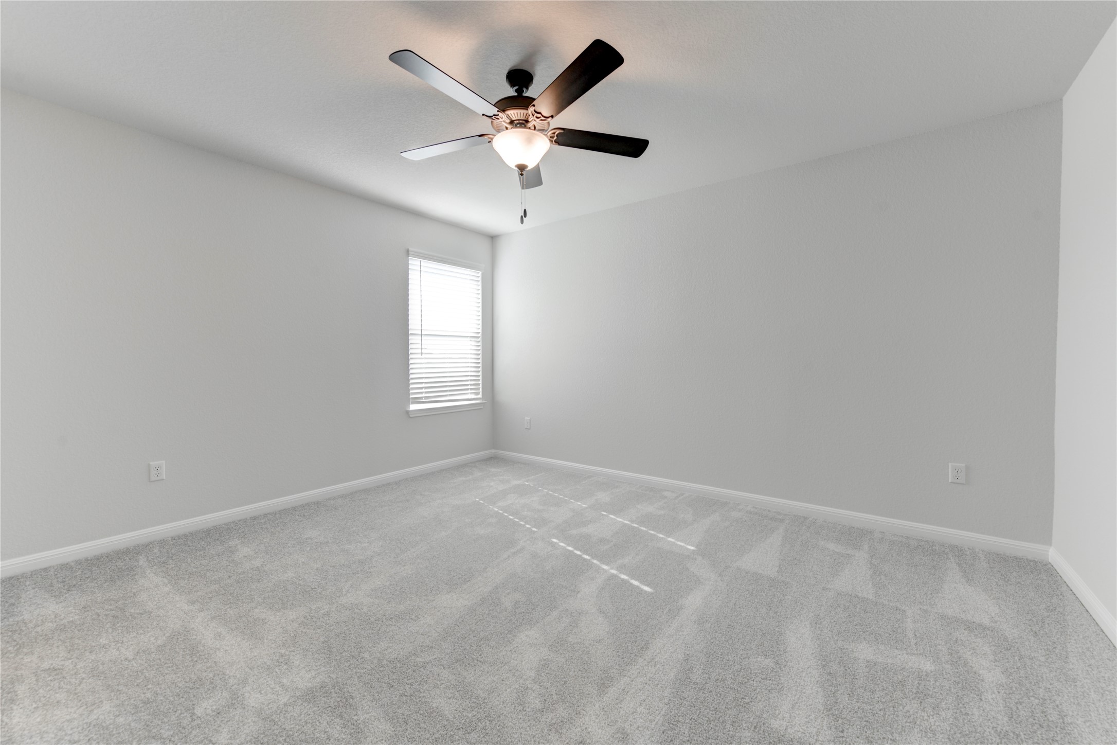 10716 Timber Brook Pass Austin, TX 78747 - Photo 27 of 33 an empty room with a window and a fan