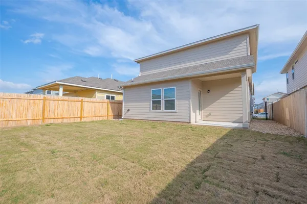 a view of an house with backyard and space