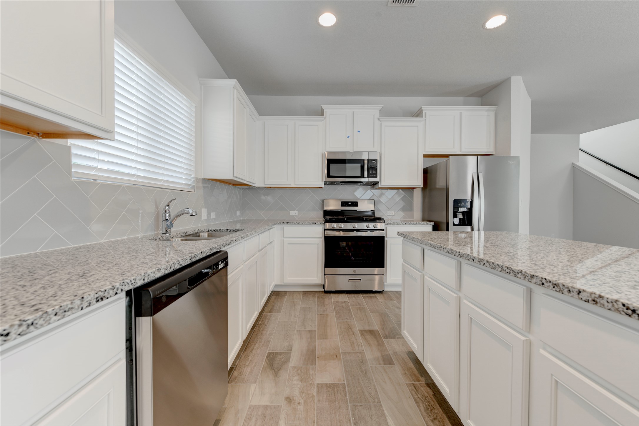 10716 Timber Brook Pass Austin, TX 78747 - Photo 8 of 33 a kitchen with kitchen island granite countertop a sink a counter top space stainless steel appliances and cabinets