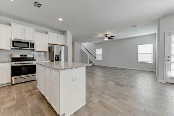 a kitchen with a sink appliances and cabinets