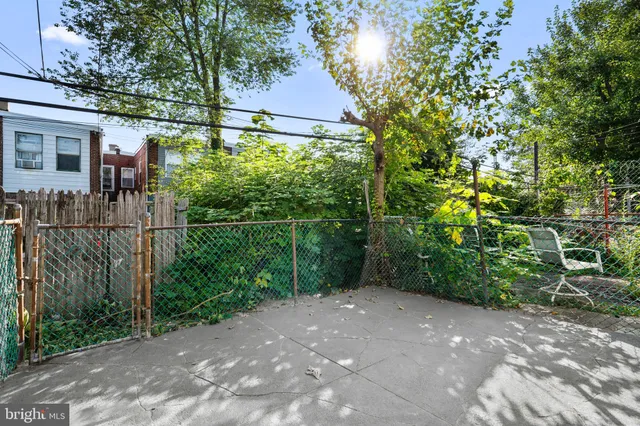 a view of a pathway of a house and trees all around