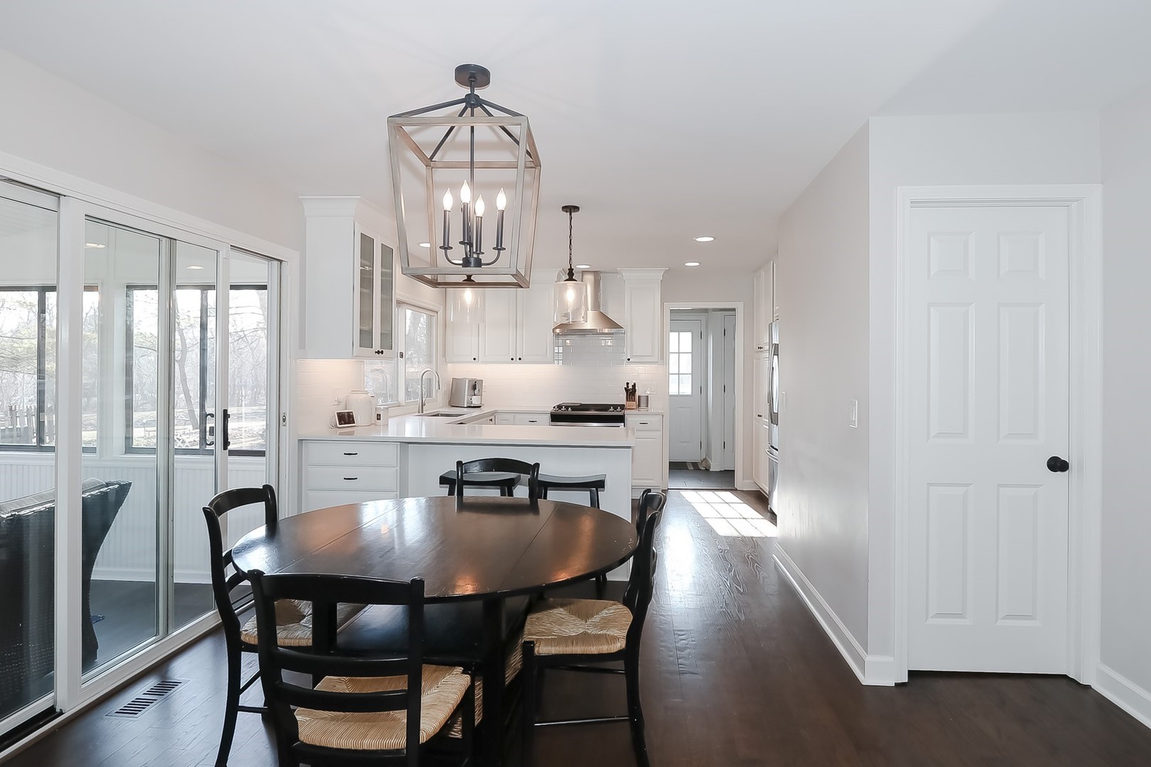879 Georgetowne Lane Barrington, IL 60010 - Photo 12 of 44 a dining room with furniture a chandelier and wooden floor