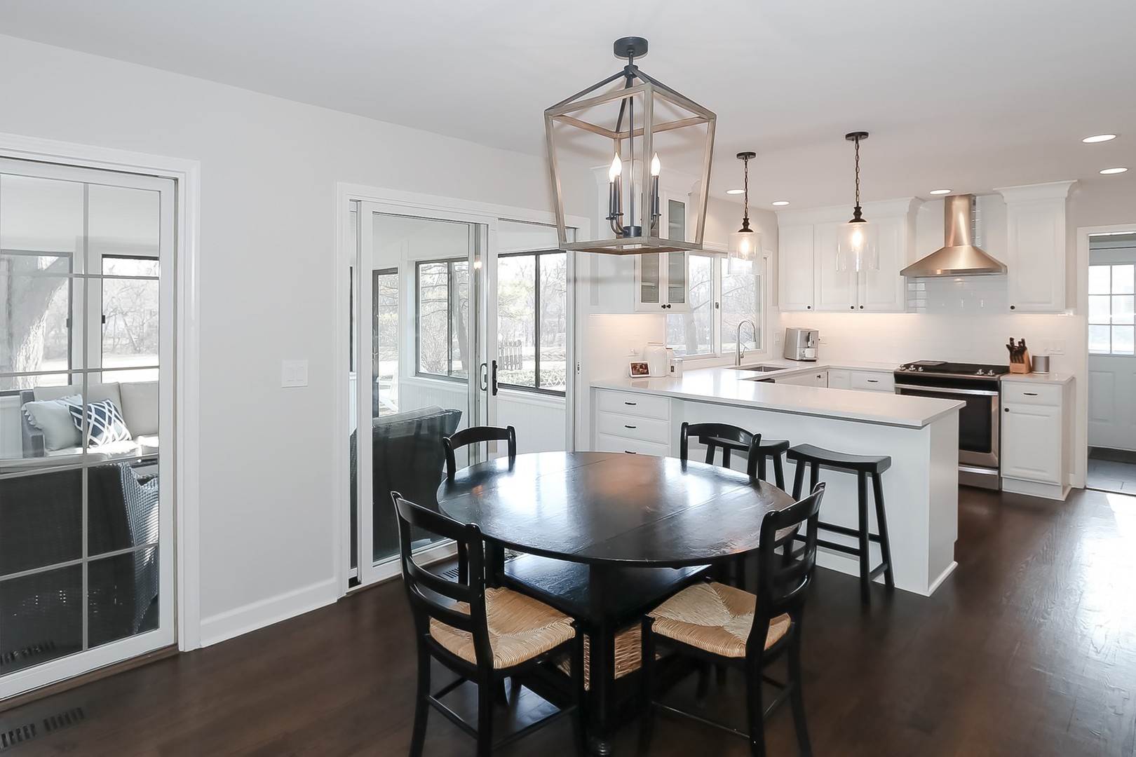879 Georgetowne Lane Barrington, IL 60010 - Photo 13 of 44 a dining room with furniture a chandelier and wooden floor