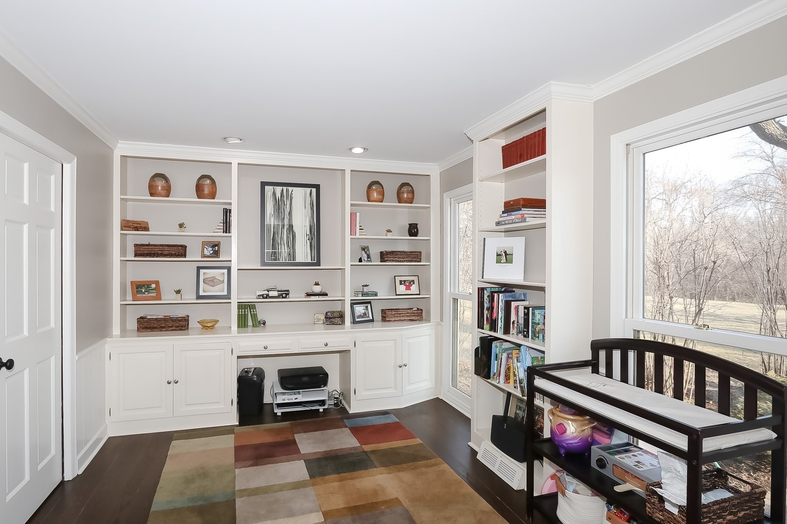 879 Georgetowne Lane Barrington, IL 60010 - Photo 17 of 44 a living room with furniture a rug and a bookshelf