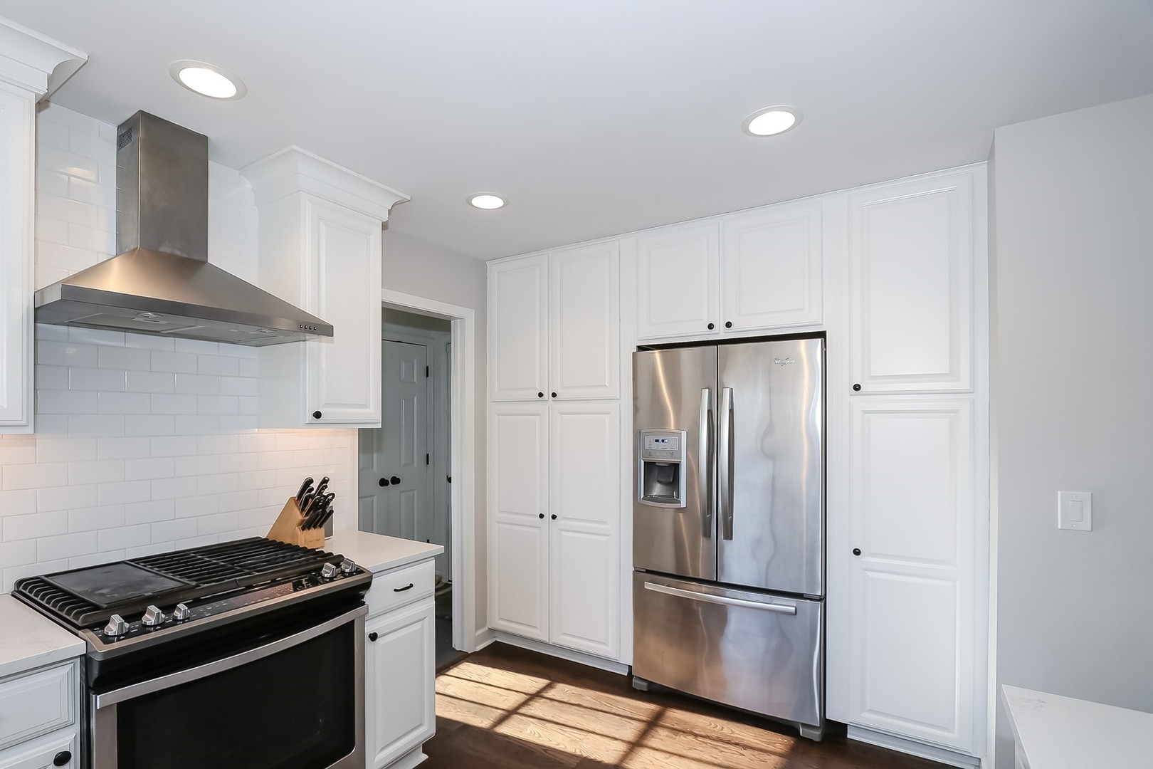 879 Georgetowne Lane Barrington, IL 60010 - Photo 6 of 44 a kitchen with stainless steel appliances granite countertop a refrigerator and a stove top oven