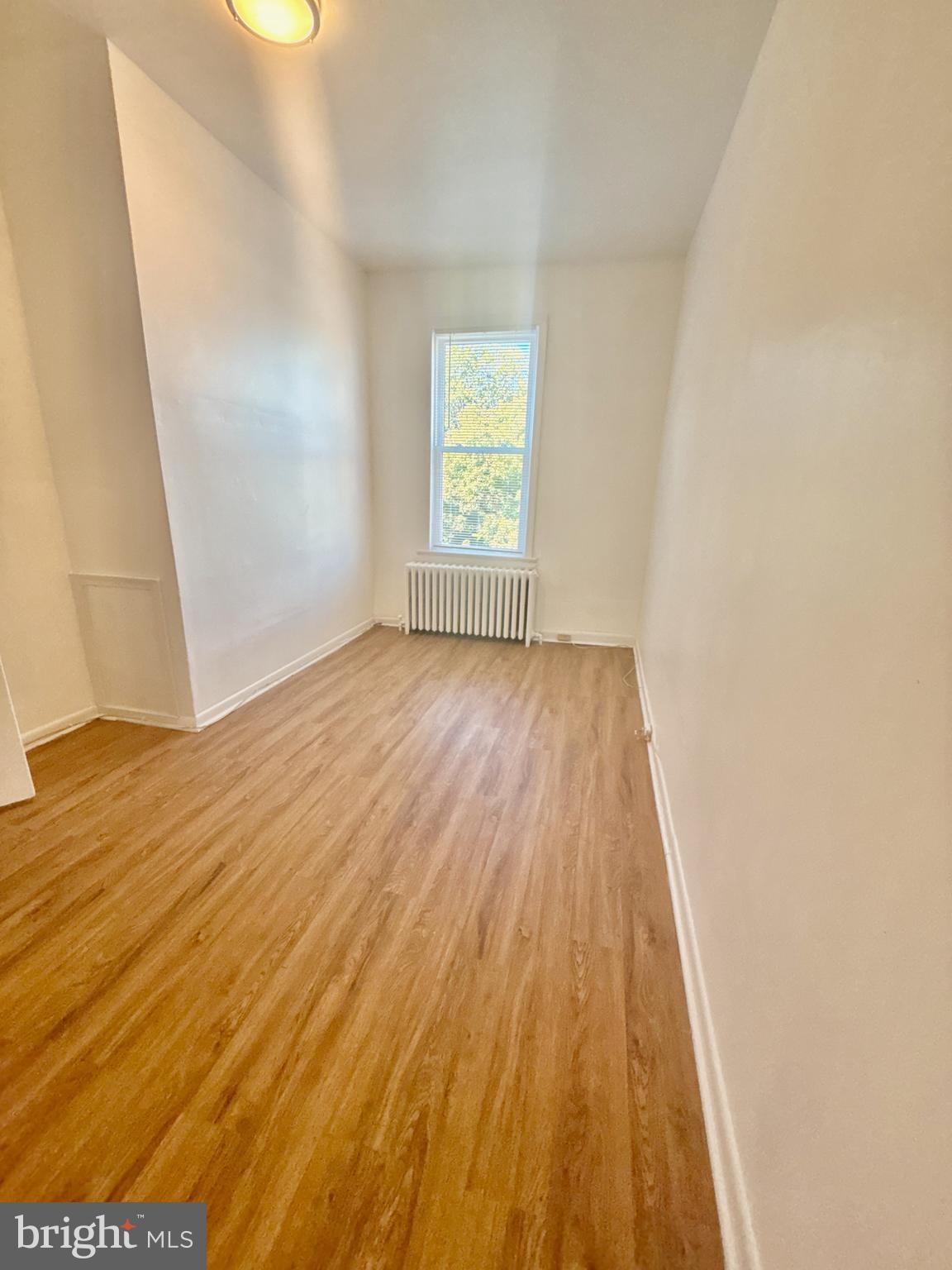 622 11th Street Northeast Washington, DC 20002 - Photo 8 of 15 an empty room with wooden floor and windows