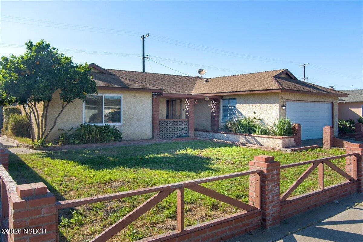 321 North Z Street Lompoc, CA 93436 - Photo 27 of 33 a view of house with a yard and potted plants