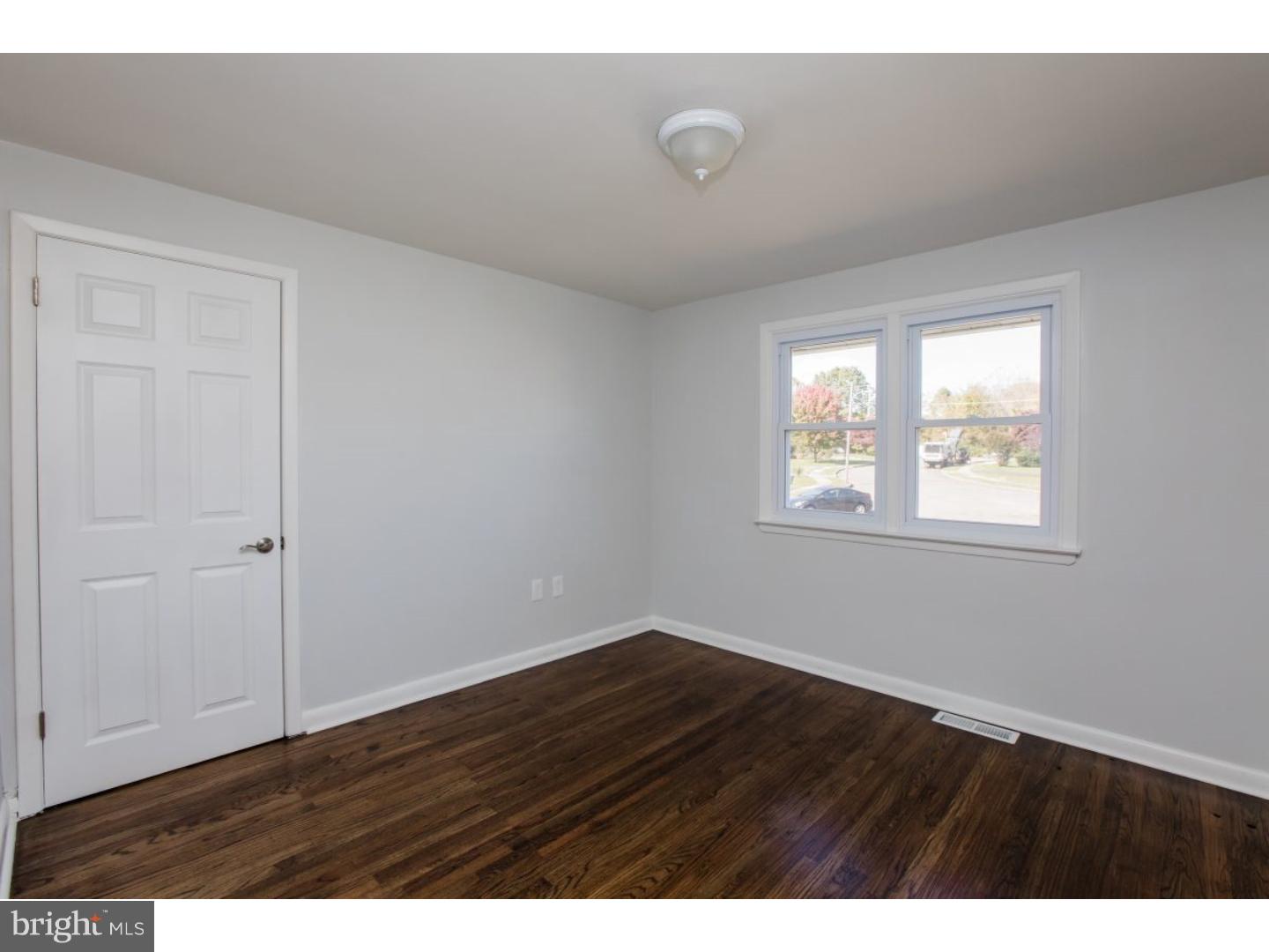 810 Coppock Lane Springfield, PA 19064 - Photo 11 of 24 a view of an empty room with wooden floor and a window