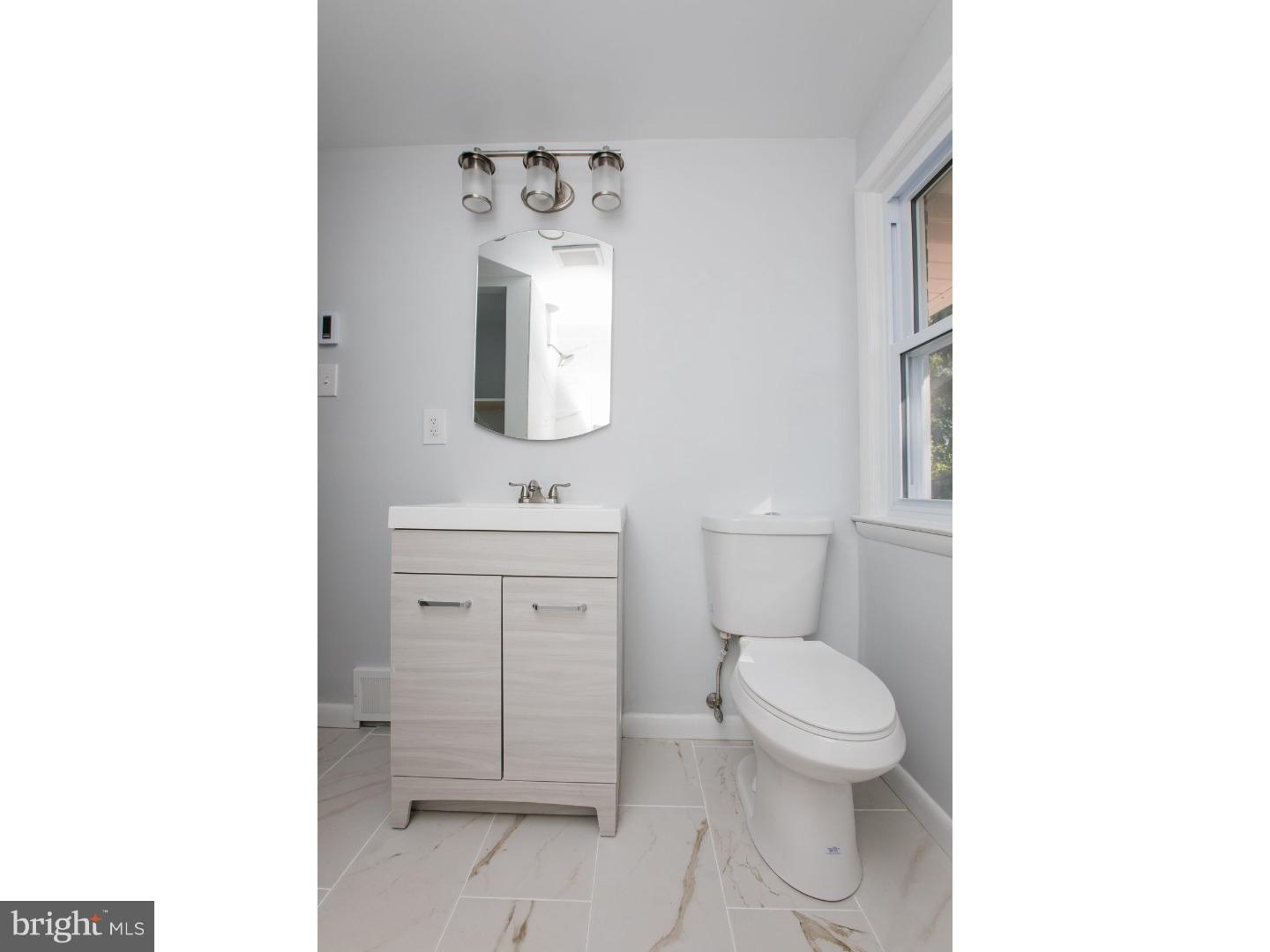 810 Coppock Lane Springfield, PA 19064 - Photo 16 of 24 a bathroom with a toilet sink and mirror