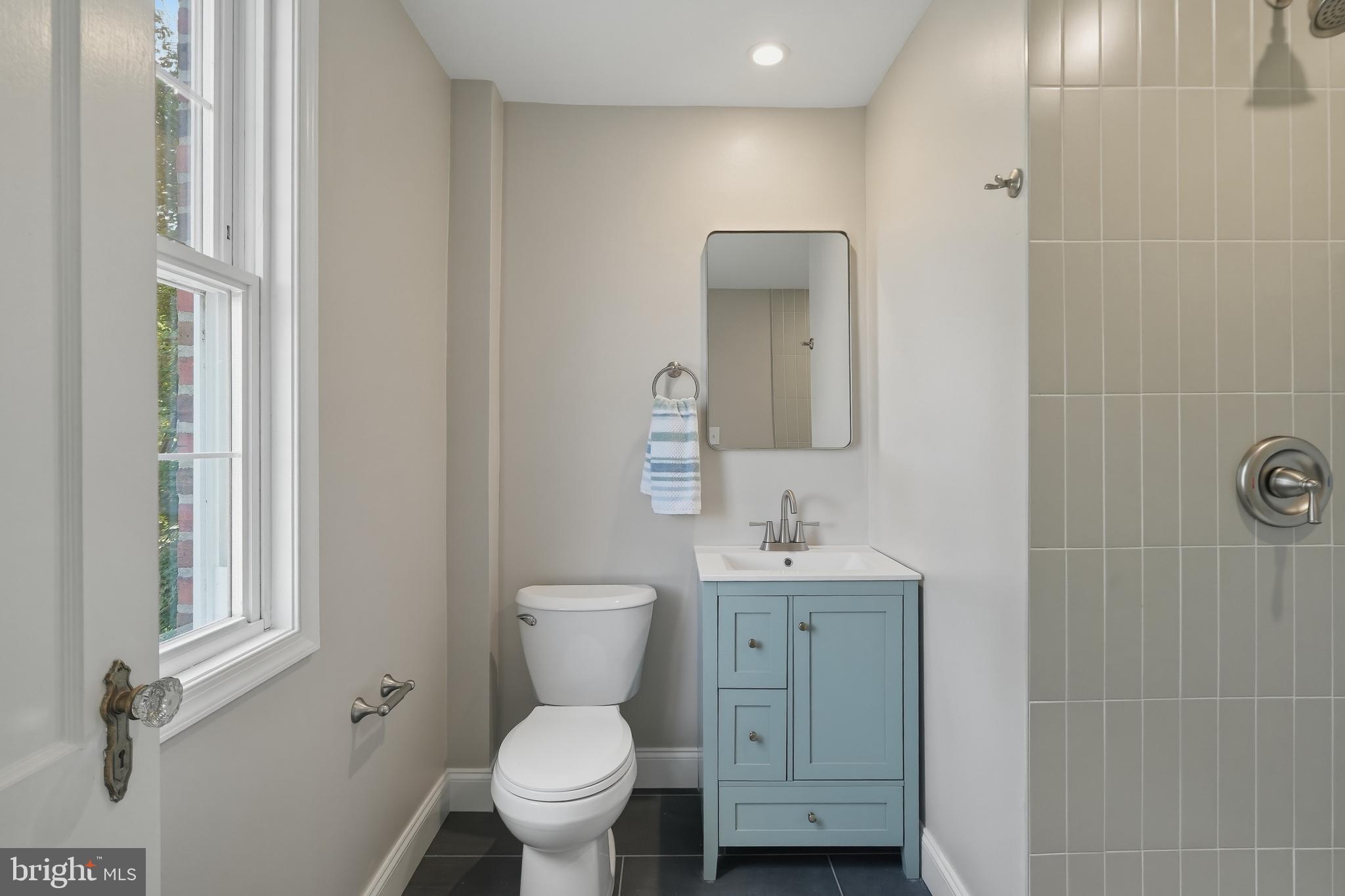800 Pleasant Hill Road Wallingford, PA 19086 - Photo 22 of 34 a bathroom with a toilet a sink a mirror and a shower