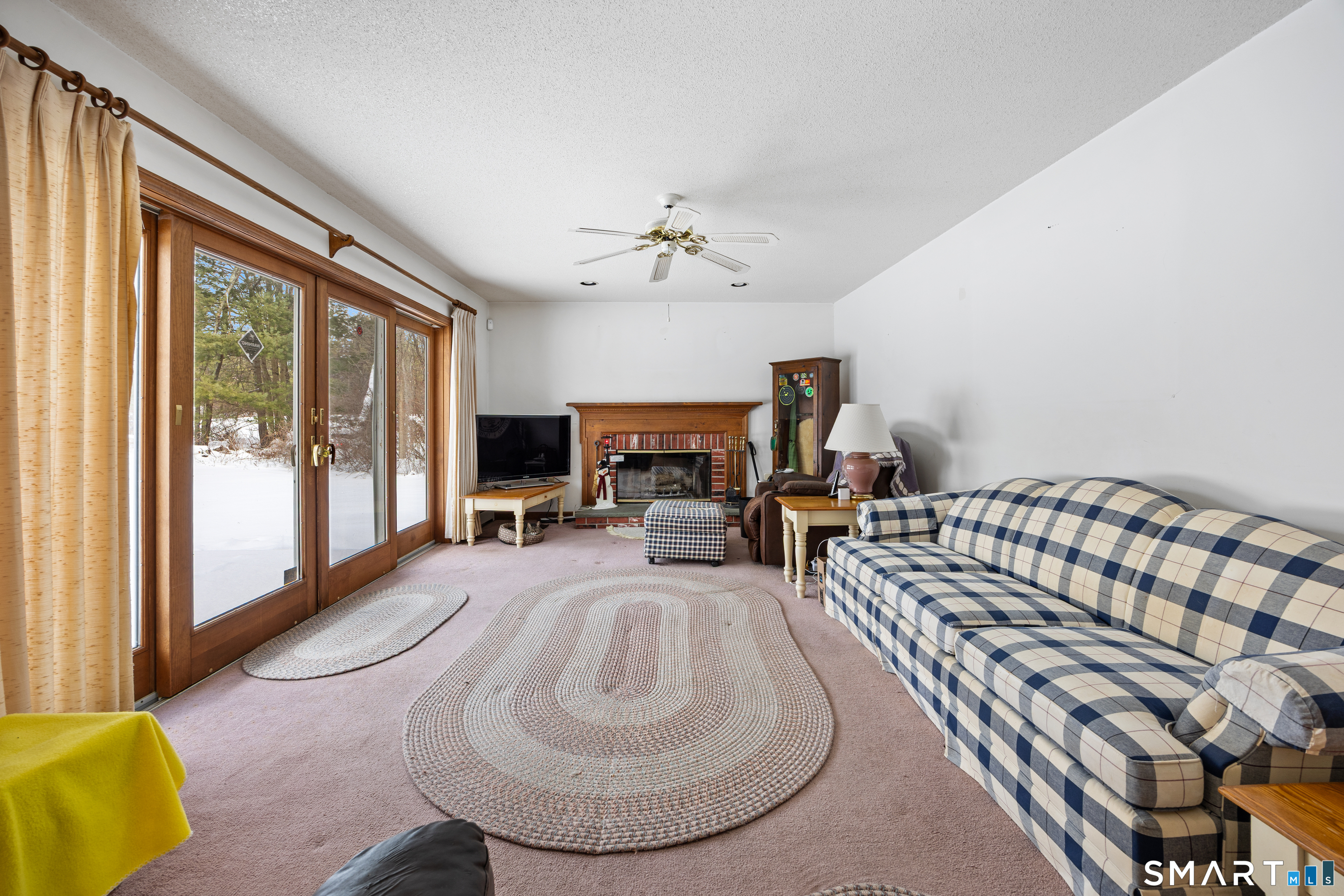 115 Alain White Road Morris, CT 06763 - Photo 18 of 36 Family room with fireplace open to kitchen.