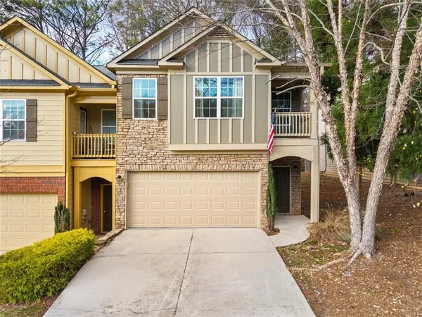 a front view of a house with a yard