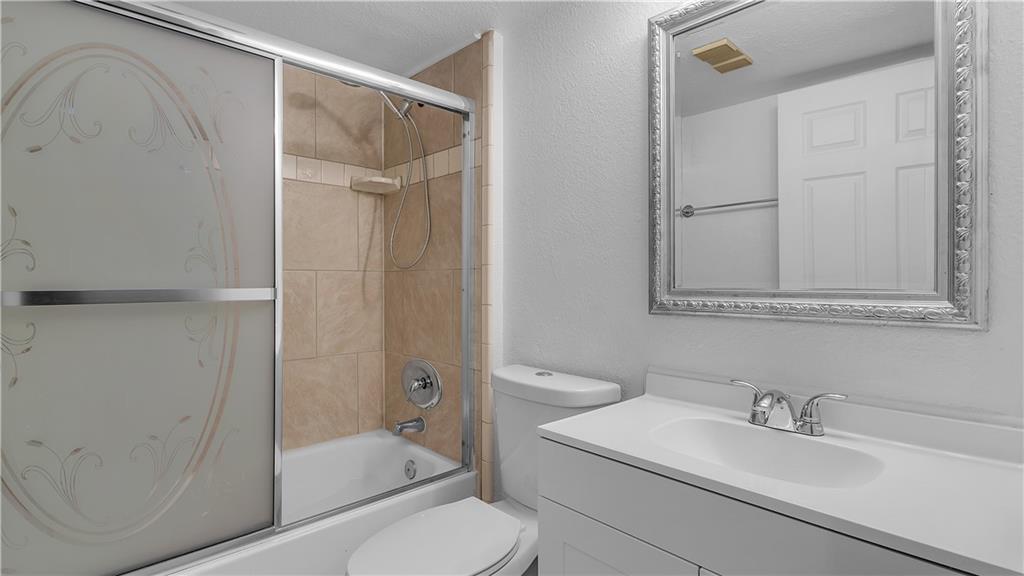 5681 Riverside Drive, Unit 101A6 Coral Springs, FL 33067 - Photo 17 of 24 a bathroom with a sink a toilet and shower