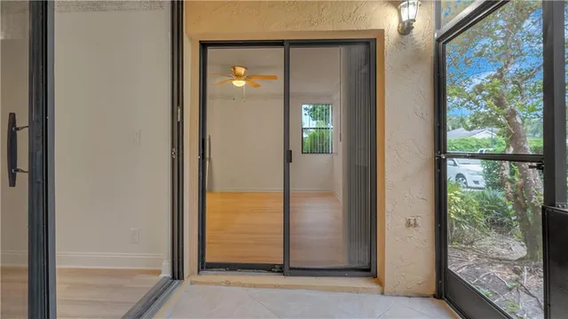 a view of a glass door and a living room