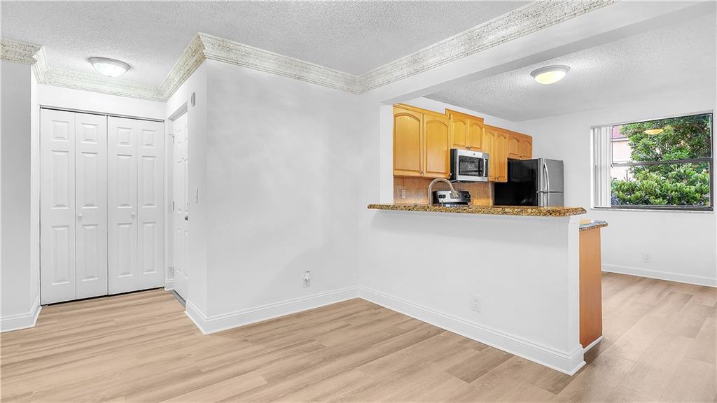5681 Riverside Drive, Unit 101A6 Coral Springs, FL 33067 - Photo 8 of 24 a view of a kitchen with a sink and a window