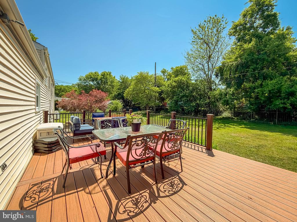 925 Big Oak Road Yardley, PA 19067 - Photo 43 of 51 a view of a patio with dining table and chairs with wooden floor and fence