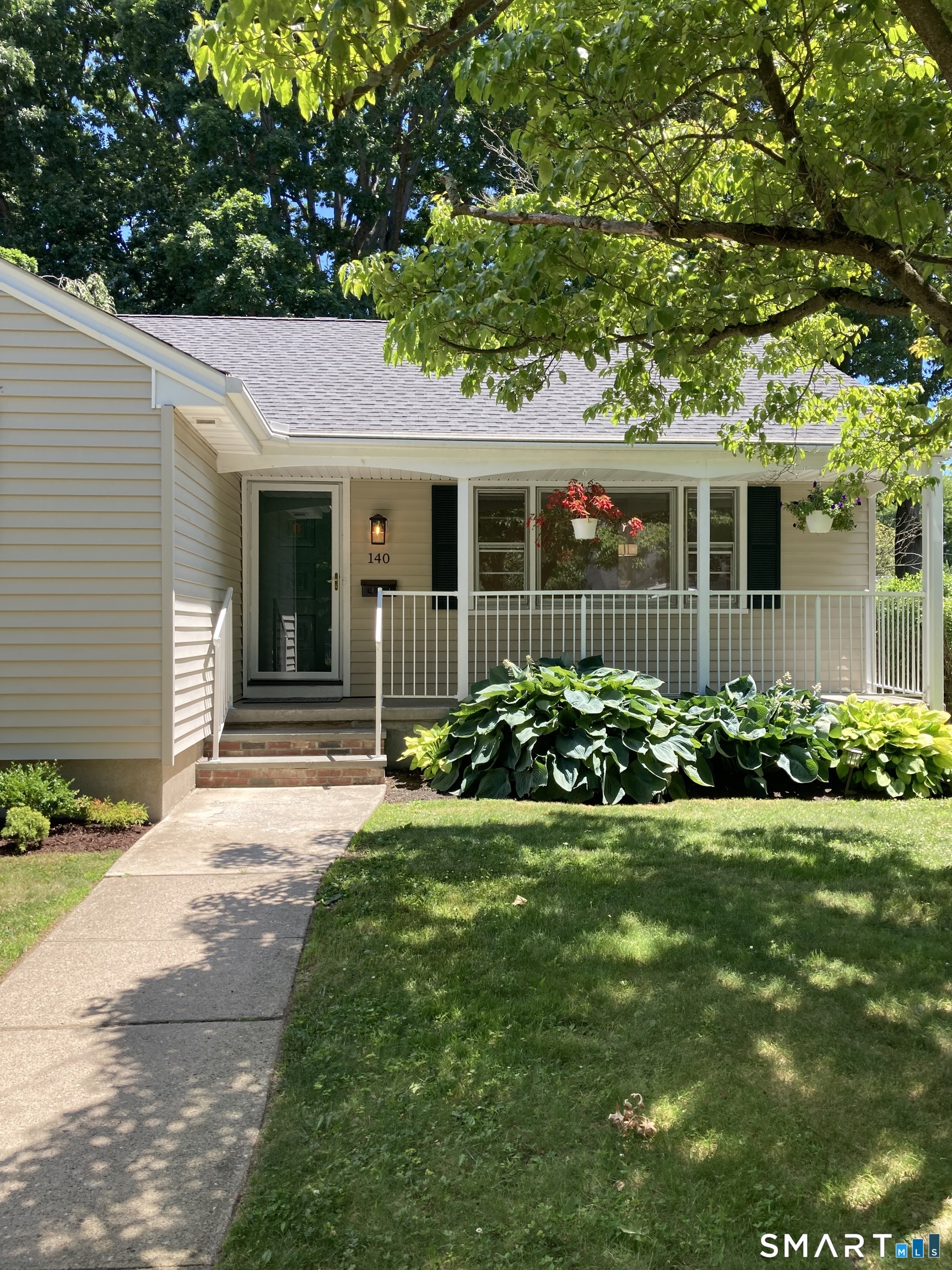 140 Spring Street Stratford, CT 06614 - Photo 5 of 29 a front view of a house with a yard