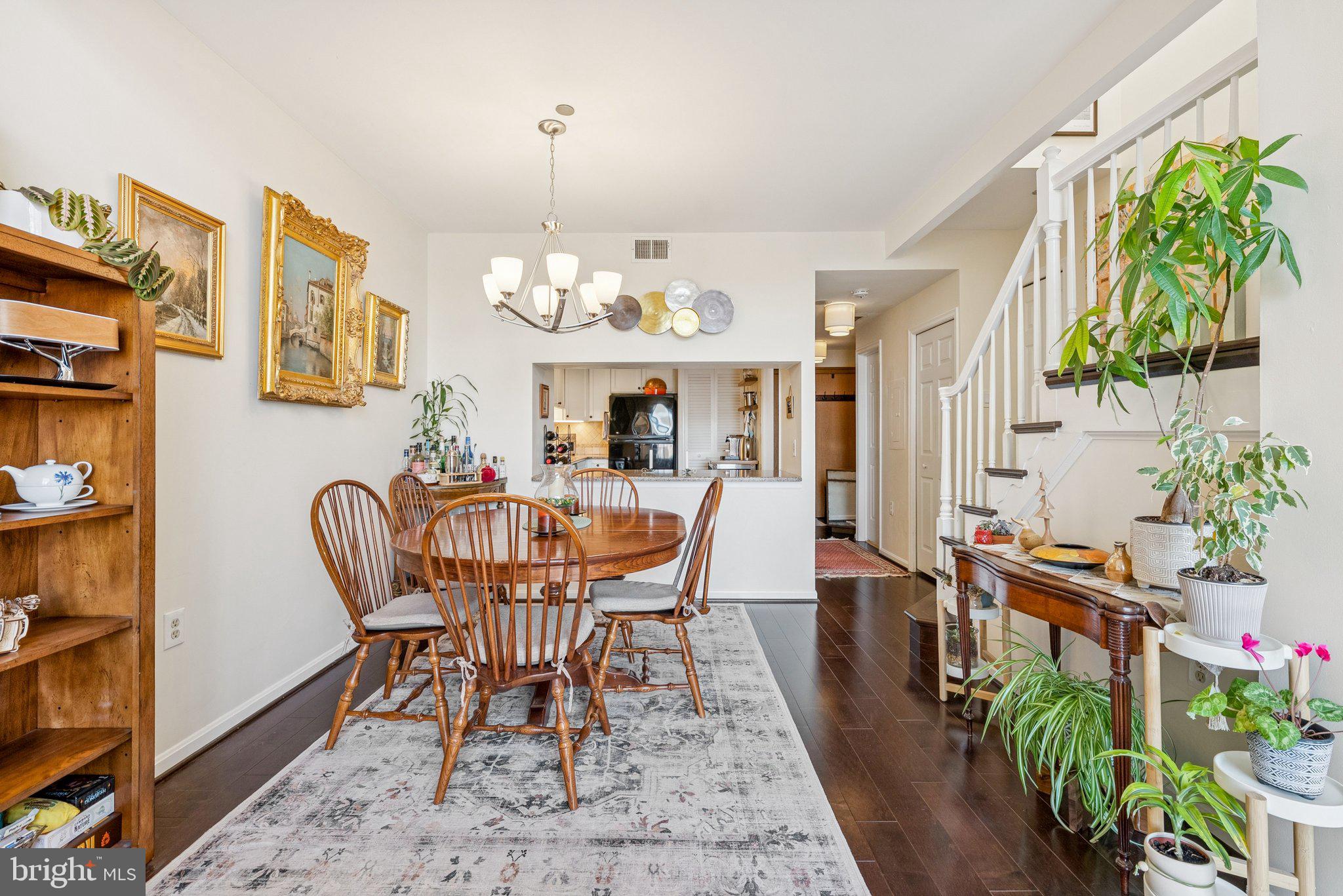 1301 North Courthouse Road, Unit 1810 Arlington, VA 22201 - Photo 8 of 29 a dining room with furniture potted plants and wooden floor