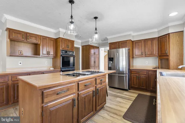 a kitchen with a stove sink and refrigerator