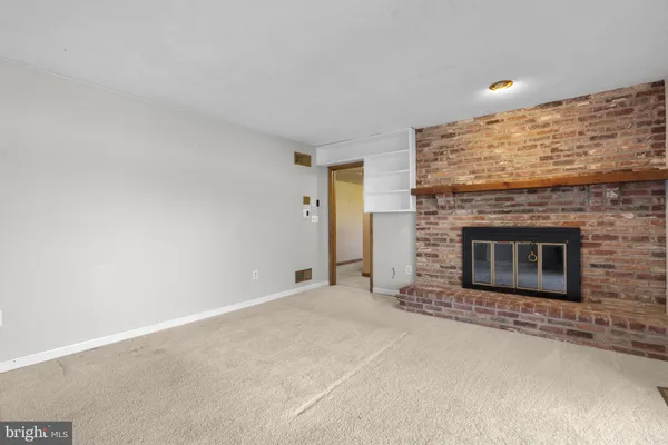 a view of empty room with a fireplace