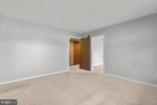 a view of an empty room and a window
