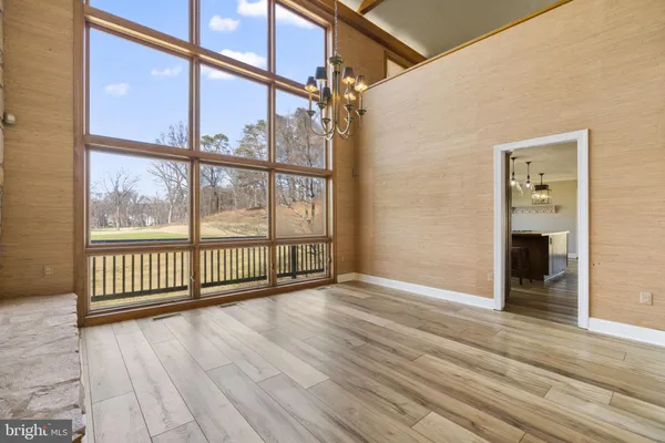 a view of a room with wooden floor and windows