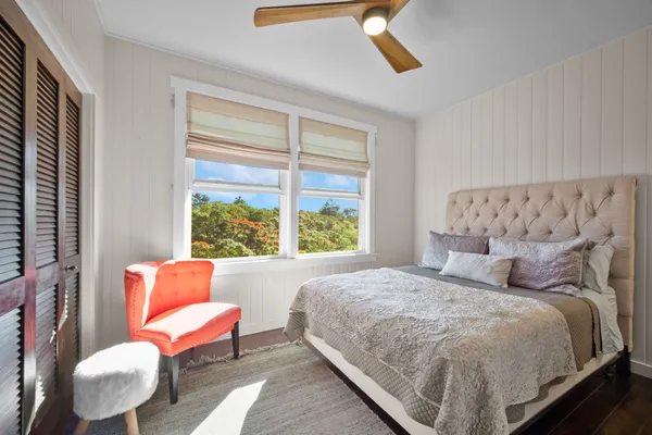 a bedroom with bed and a couch