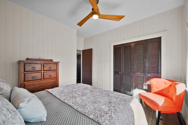 a bedroom with a bed and dresser