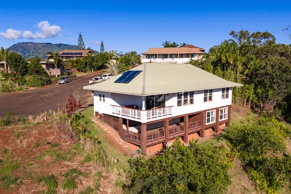 a aerial view of a house with a yard and balcony