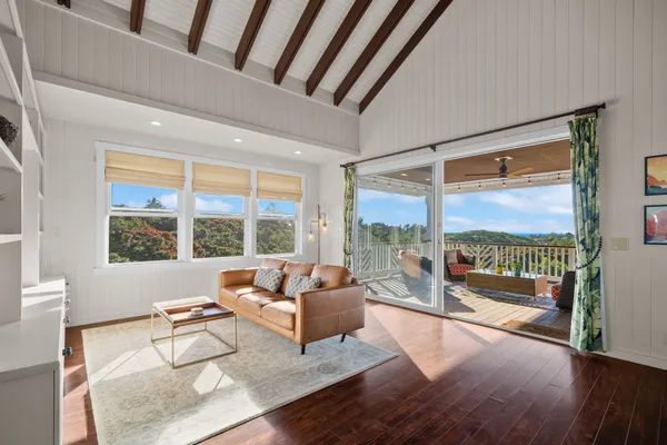 a living room with furniture and a large window with outer view