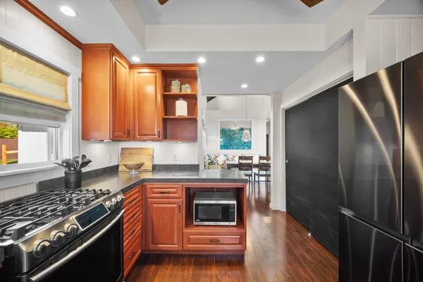 a kitchen with stainless steel appliances granite countertop a stove a refrigerator and a stove