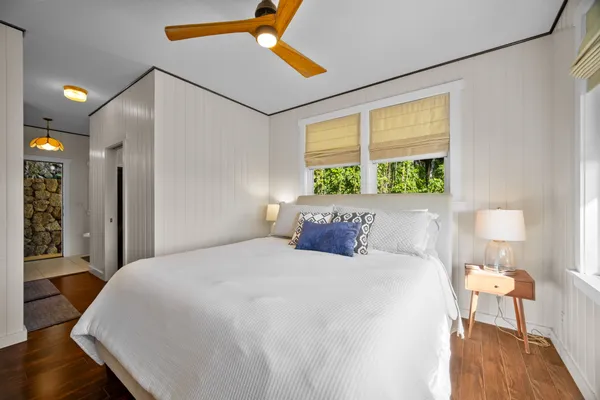 a bedroom with a bed window and a table