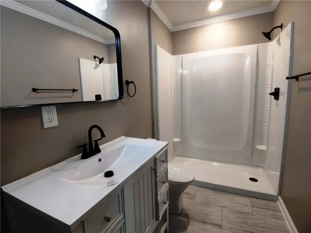 a bathroom with a sink a mirror and a shower