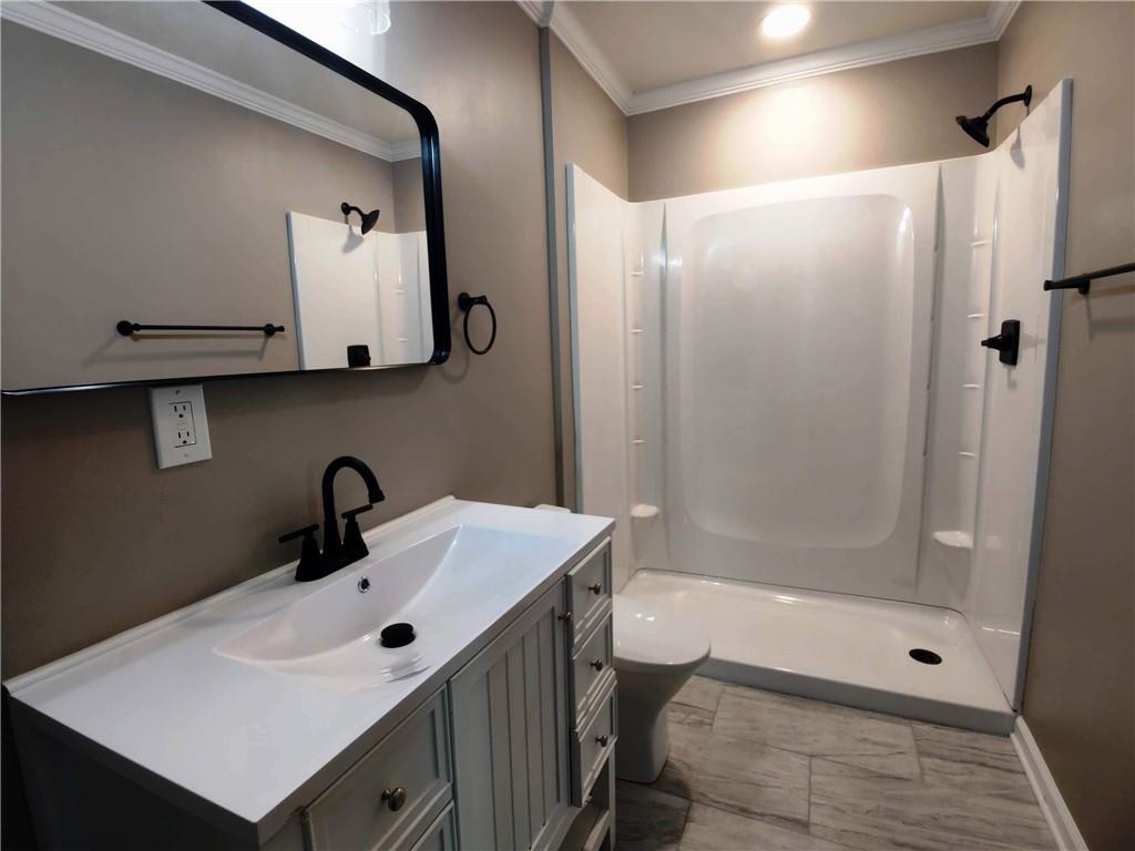 907 Gadsden Road Southwest Cave Spring, GA 30124 - Photo 13 of 26 a bathroom with a sink a mirror and a shower