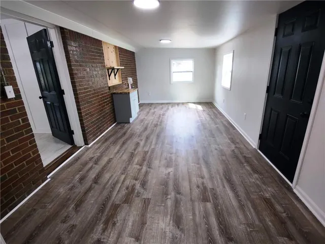 a view of a room with wooden floor and window