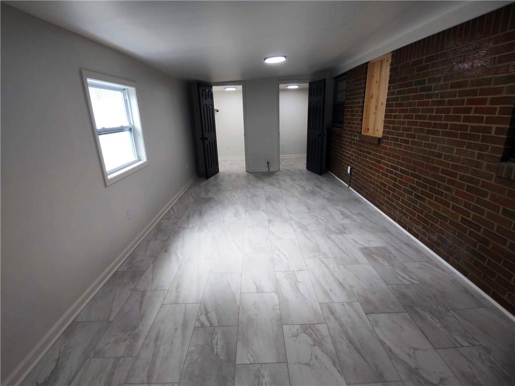 907 Gadsden Road Southwest Cave Spring, GA 30124 - Photo 17 of 26 an empty room with wooden floor and windows