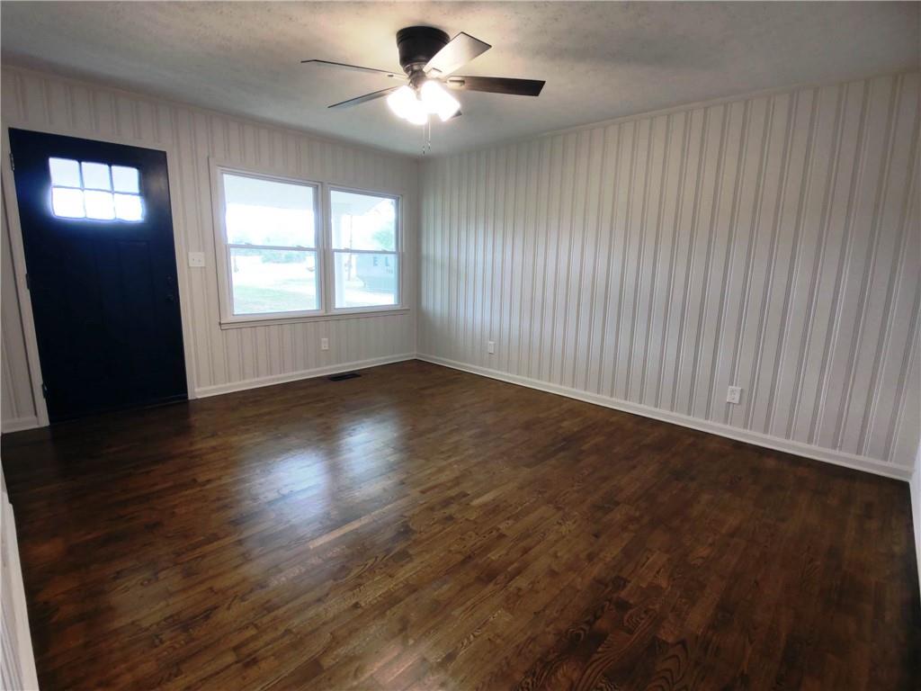907 Gadsden Road Southwest Cave Spring, GA 30124 - Photo 2 of 26 an empty room with wooden floor and windows