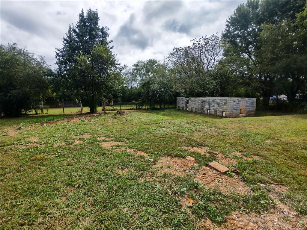 907 Gadsden Road Southwest Cave Spring, GA 30124 - Photo 24 of 26 a view of a green field with trees in the background