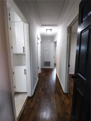 a view of a hallway with wooden floor