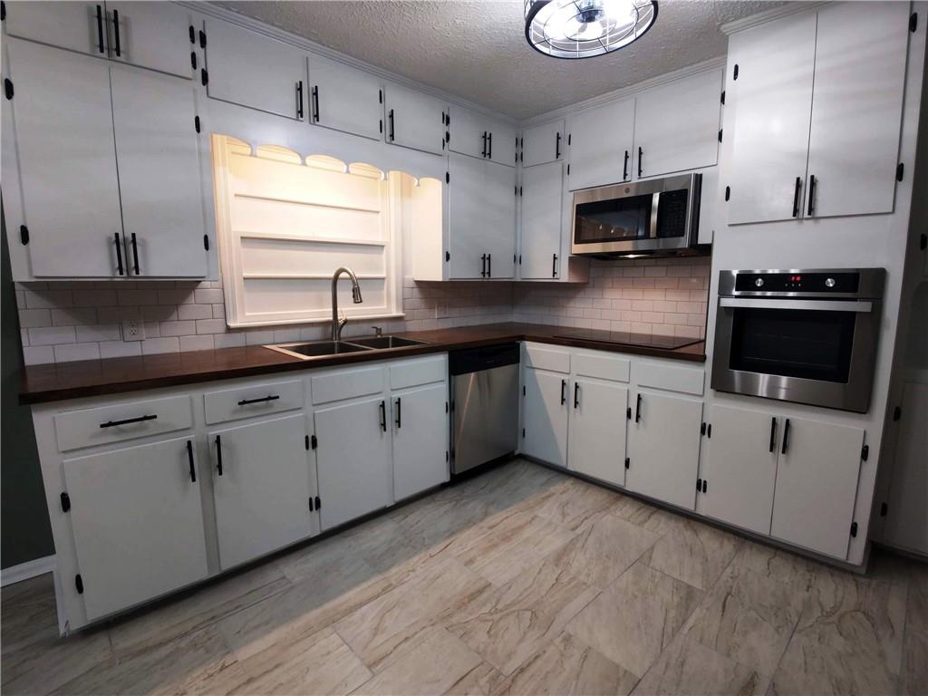 907 Gadsden Road Southwest Cave Spring, GA 30124 - Photo 6 of 26 a kitchen with appliances cabinets and a sink