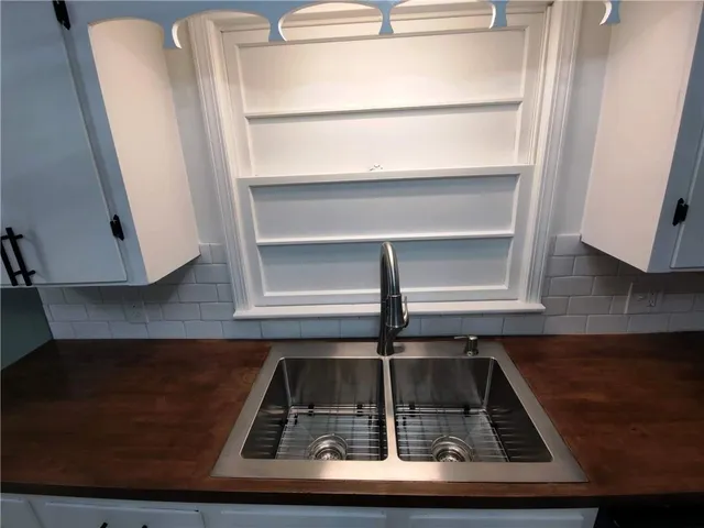 a refrigerator sitting on top of a kitchen