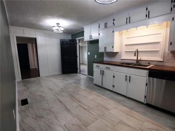 a kitchen with stainless steel appliances granite countertop a sink and cabinets