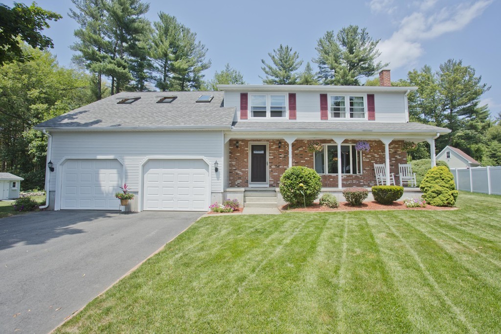 97 Calley Street Springfield, MA 01129 - Photo 1 of 30 a front view of a house with a yard and porch