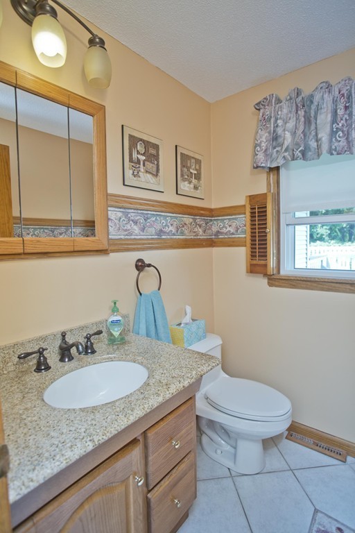 97 Calley Street Springfield, MA 01129 - Photo 15 of 30 a bathroom with a granite countertop toilet sink and mirror