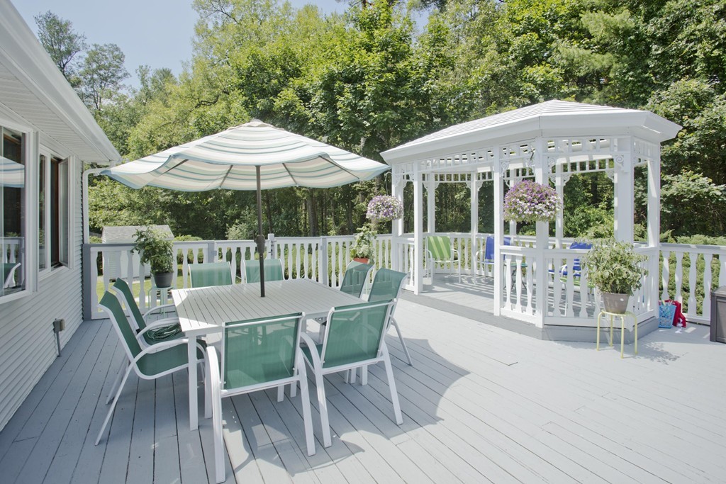 97 Calley Street Springfield, MA 01129 - Photo 5 of 30 a patio with a table and chairs under an umbrella