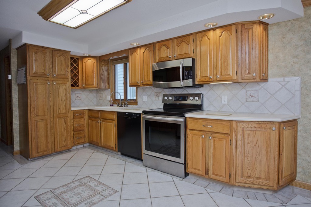 97 Calley Street Springfield, MA 01129 - Photo 8 of 30 a kitchen with stainless steel appliances granite countertop a stove top oven a sink dishwasher and granite counter top