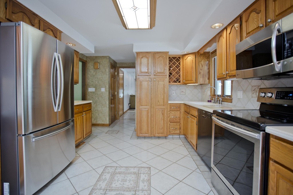 97 Calley Street Springfield, MA 01129 - Photo 9 of 30 a kitchen with stainless steel appliances granite countertop a refrigerator and a stove top oven